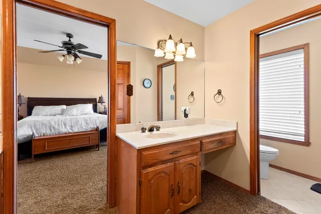a en suite bathroom with a double vanity sink a mirror and a shower