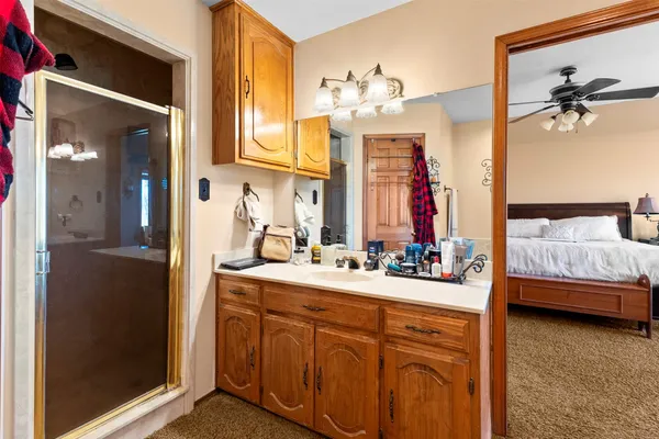 a en suite bathroom with a double vanity sink a mirror and a shower