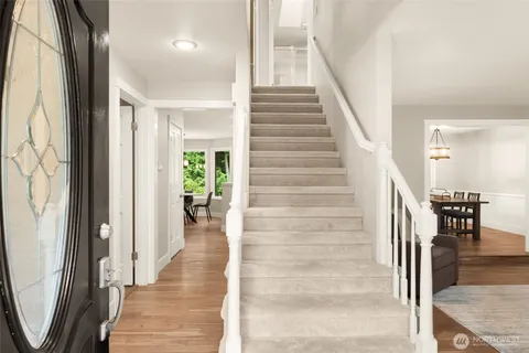 a view of a hallway with wooden floor and entryway