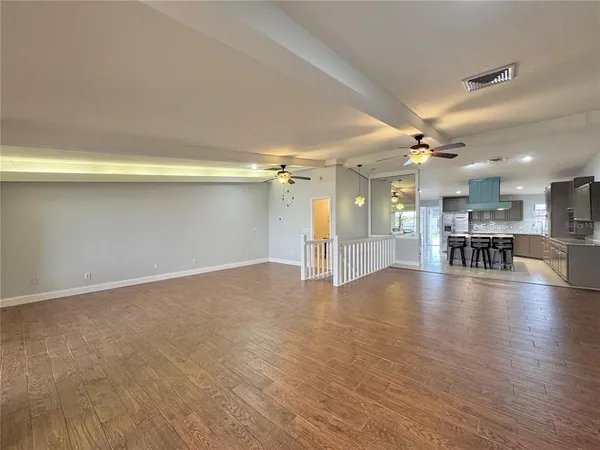 a view of empty room with wooden floor and fireplace