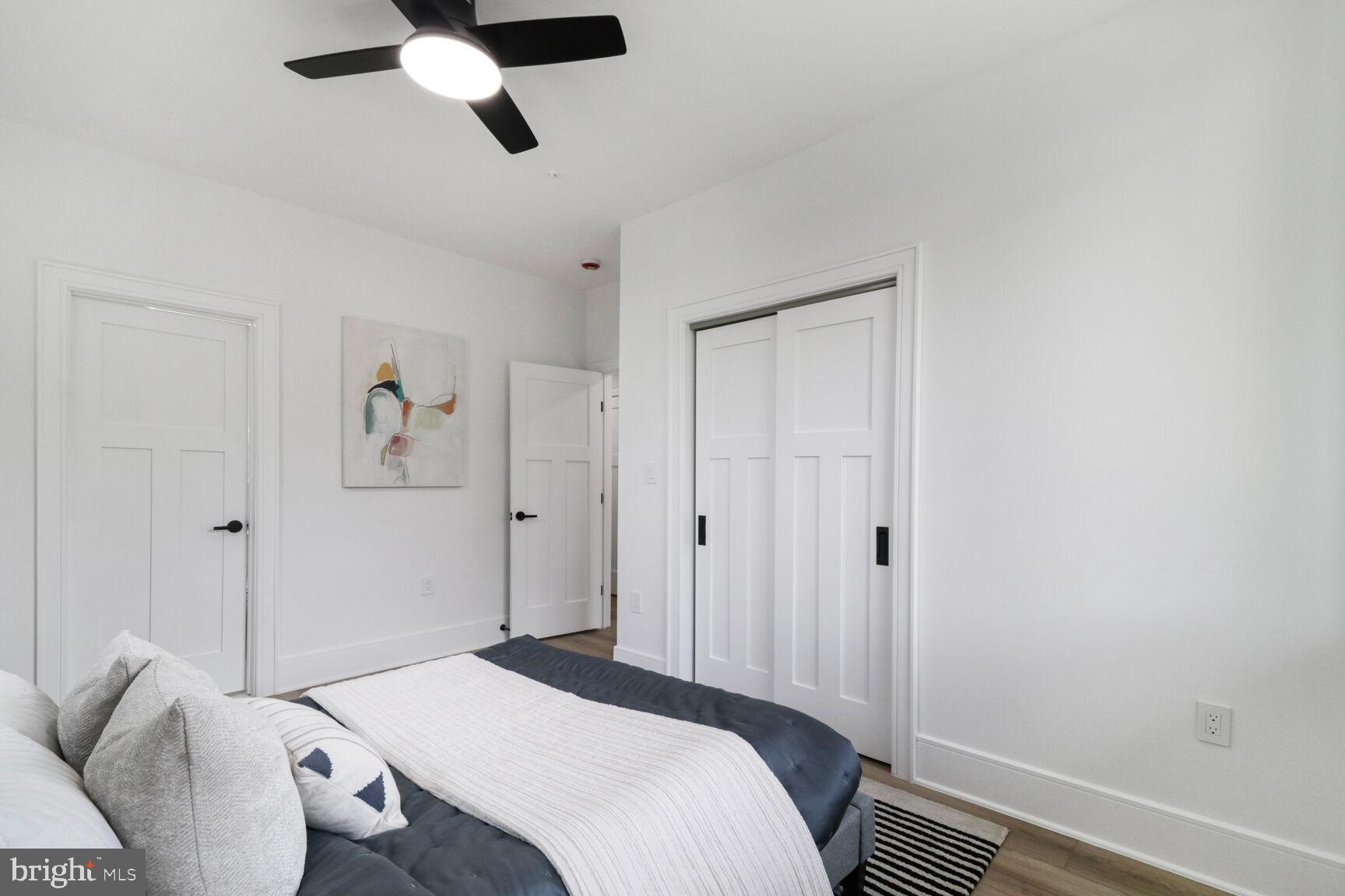 2524 41st Street Northwest, Unit 1 Washington, DC 20007 - Photo 12 of 27 a bedroom with a bed and a chandelier
