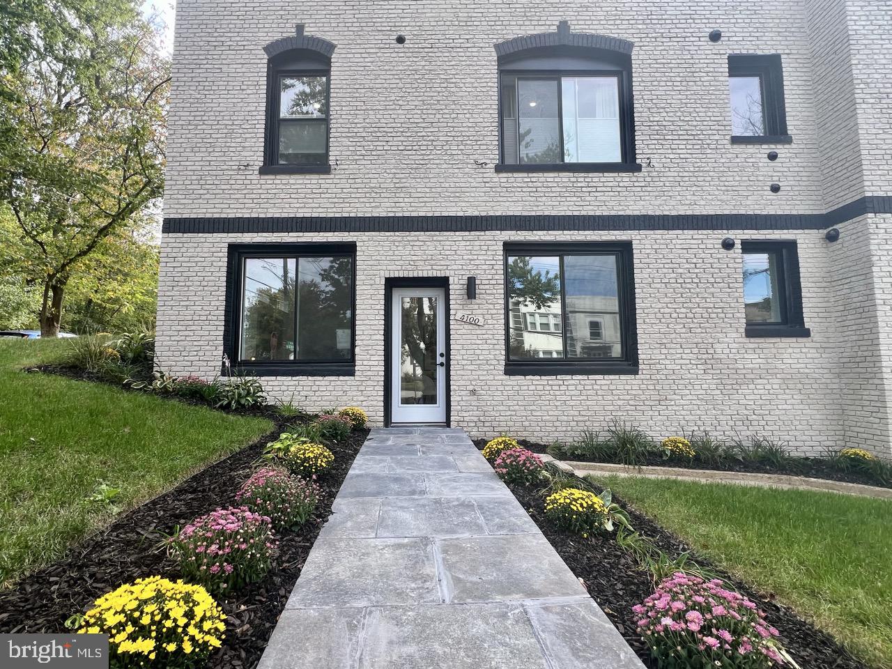 2524 41st Street Northwest, Unit 1 Washington, DC 20007 - Photo 2 of 27 a front view of a house with a yard