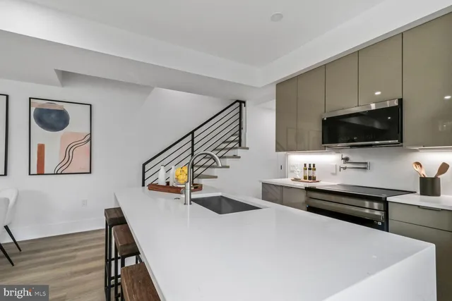 a kitchen with stainless steel appliances a table and chairs