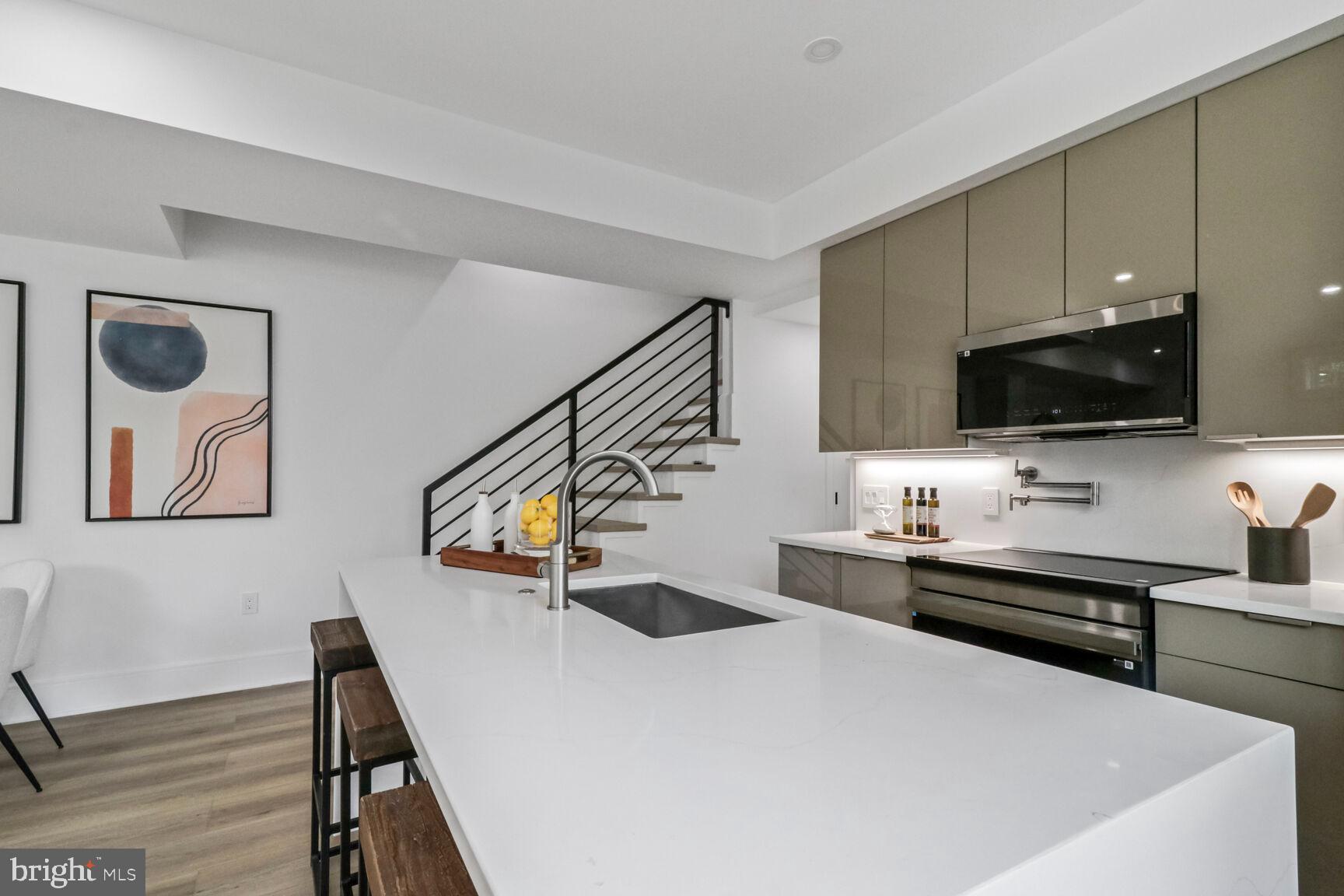 2524 41st Street Northwest, Unit 1 Washington, DC 20007 - Photo 8 of 27 a kitchen with a sink a stove and cabinets