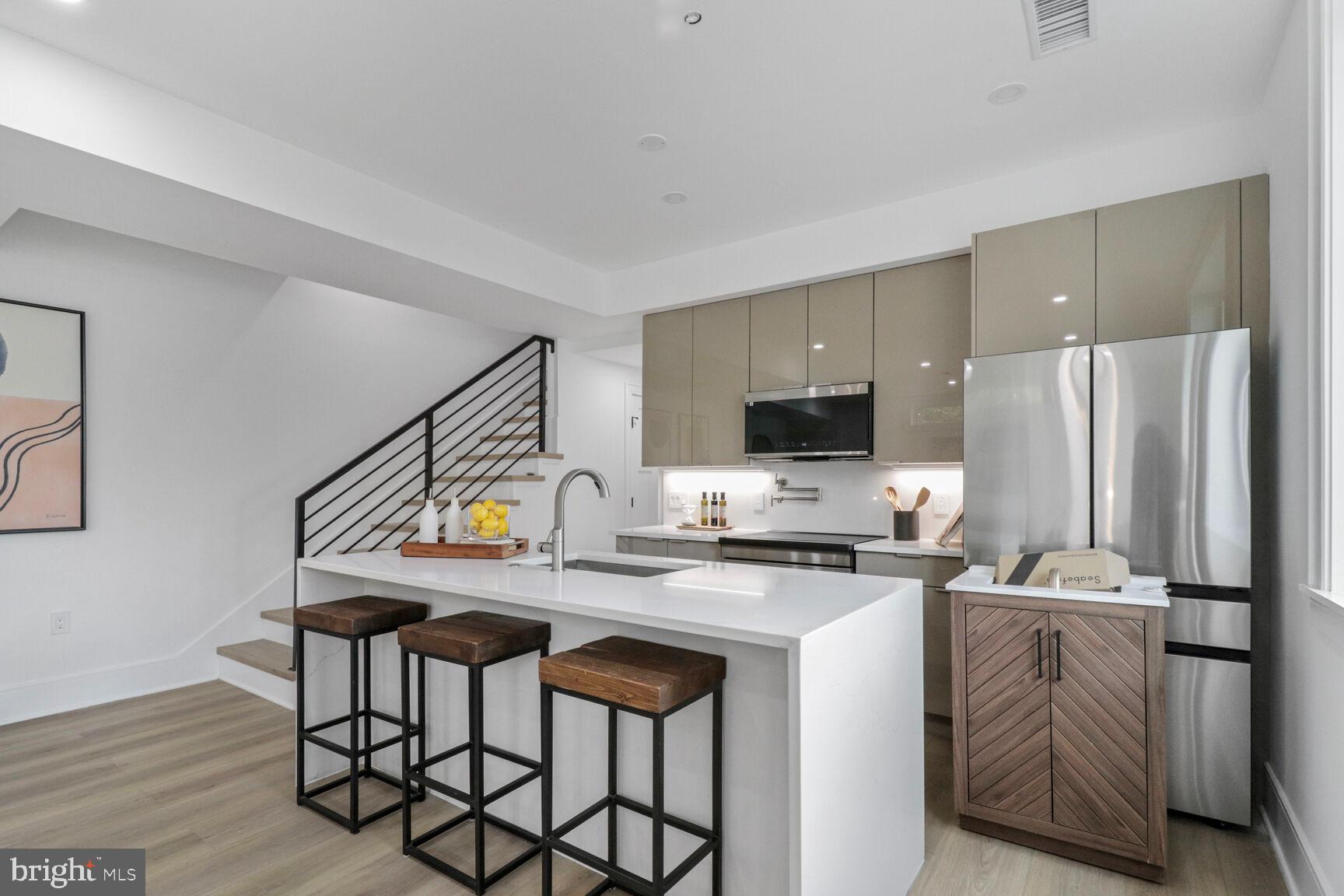 2524 41st Street Northwest, Unit 1 Washington, DC 20007 - Photo 9 of 27 a kitchen with stainless steel appliances a table and chairs
