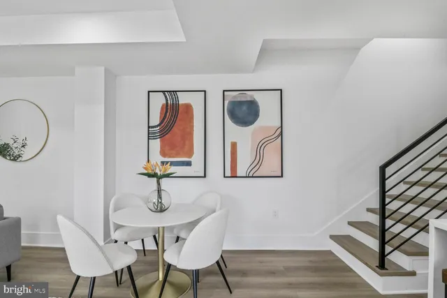 a kitchen with sink a table and chairs