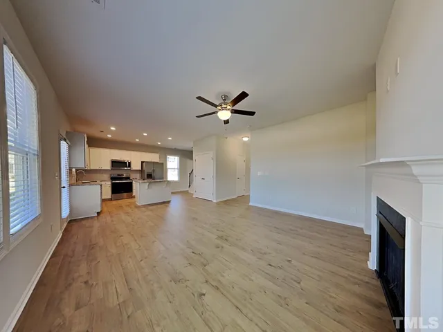 a view of a kitchen with a sink and a fireplace