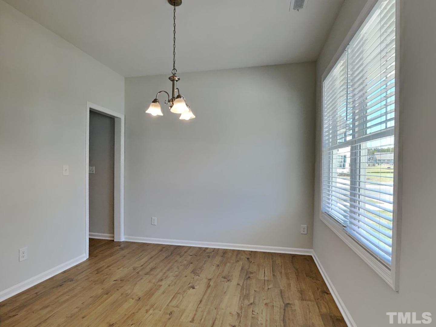 110 Shore Court Smithfield, NC 27577 - Photo 13 of 17 a view of an empty room with wooden floor and a window