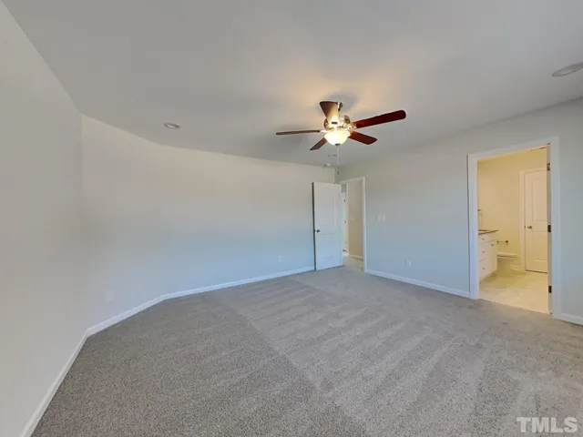 a view of a livingroom with a ceiling fan and window