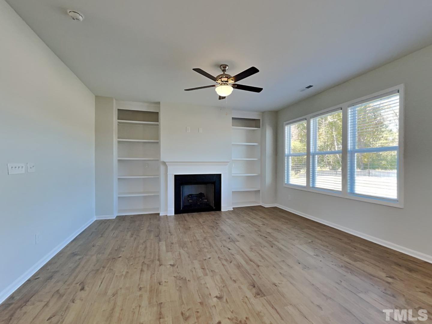 110 Shore Court Smithfield, NC 27577 - Photo 10 of 17 a view of empty room with wooden floor and fan