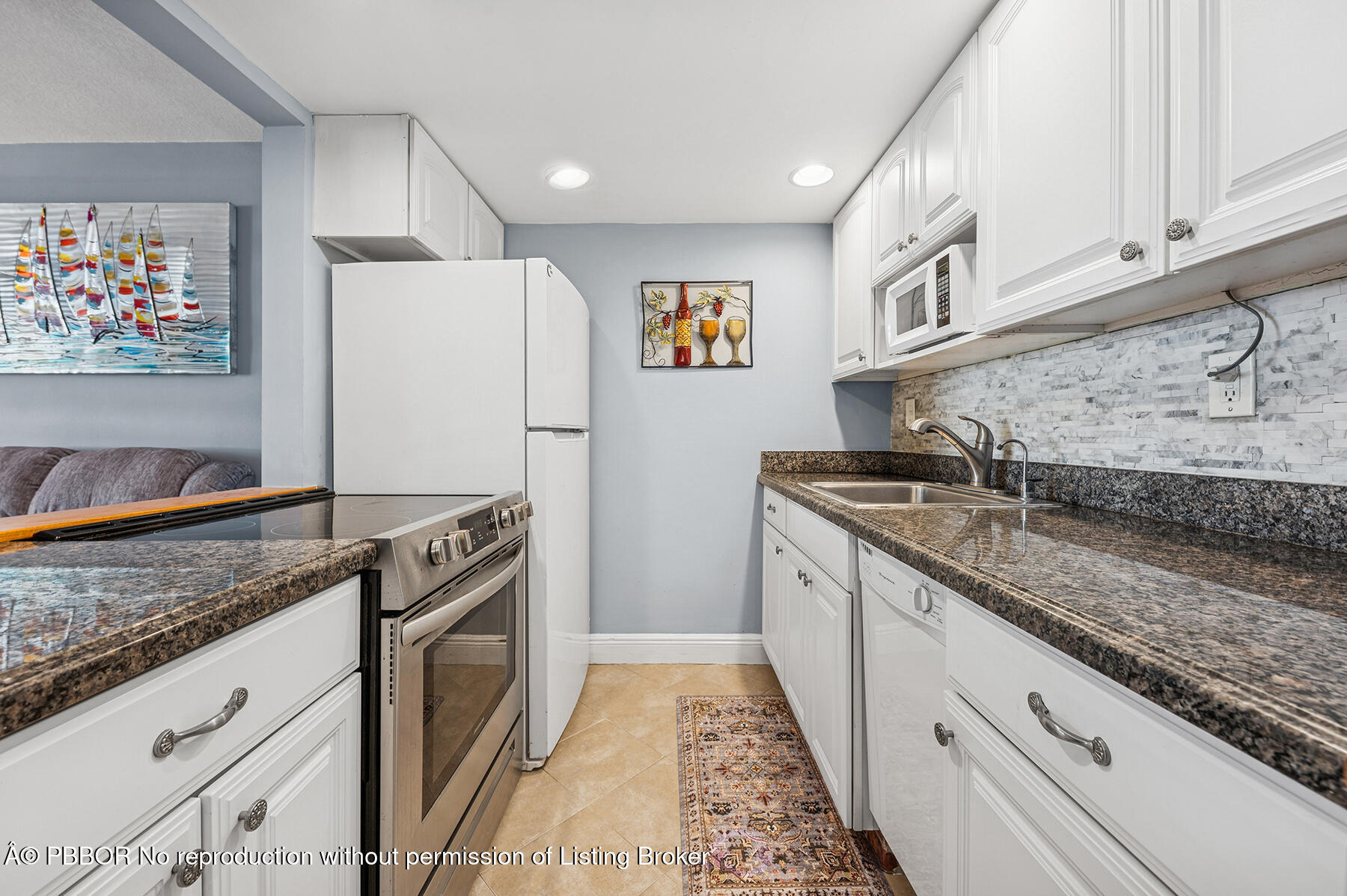 2565 South Ocean Boulevard, Unit 118 Palm Beach, FL 33480 - Photo 6 of 11 a kitchen with granite countertop stainless steel appliances a sink stove and cabinets