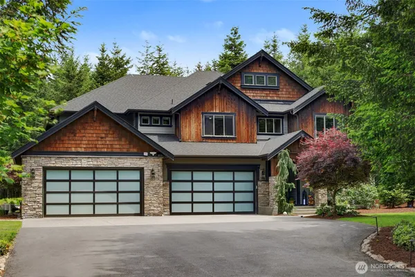 a front view of a house with a garage and a yard