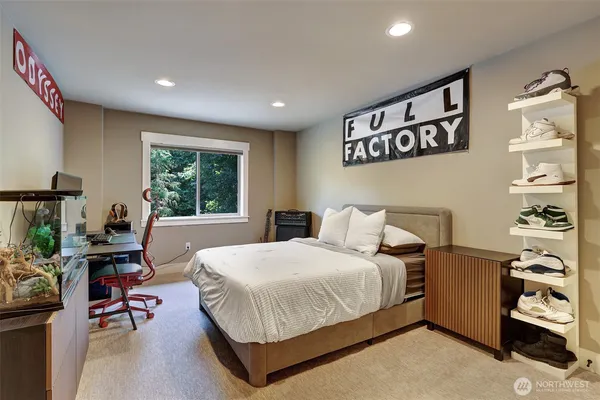 a bedroom with a bed a table and a large window