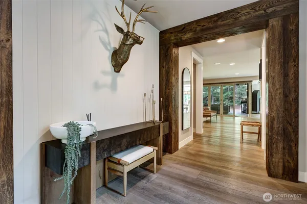 a hallway with dining room and wooden floor