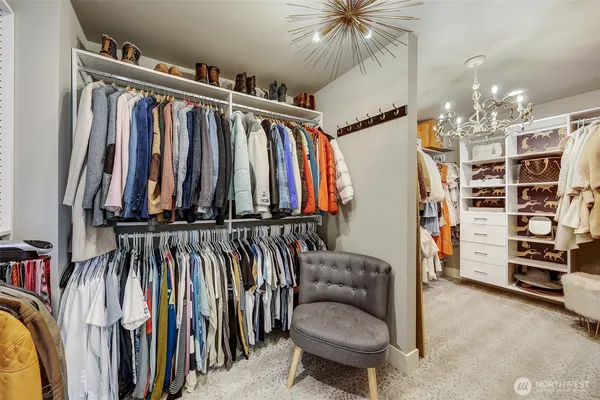 a view of walk in closet with clothes and shoes