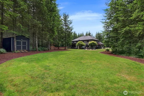 a view of a house with a yard and sitting area