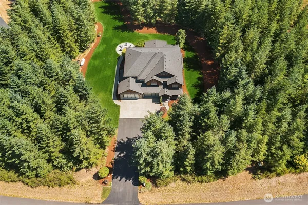 an aerial view of a house with yard