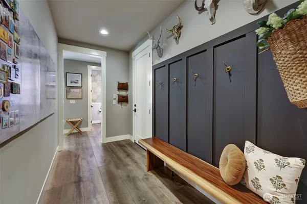 a hallway with sliding door and wooden floor