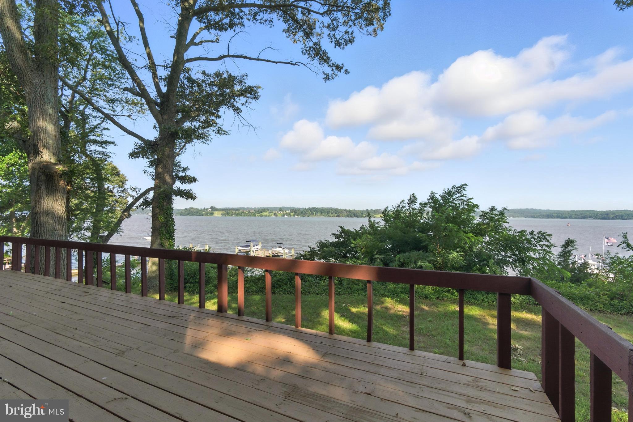 a view of roof deck with two couches and wooden floor