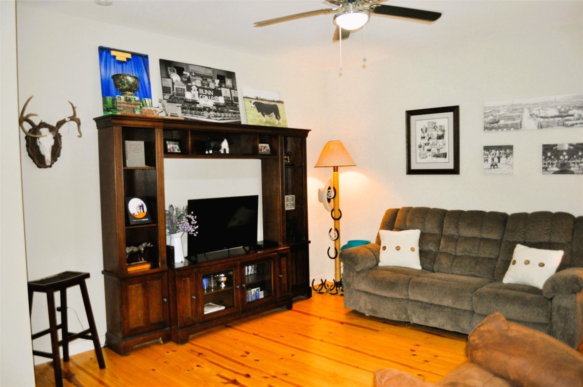 913 Independence Street Brenham, TX 77833 - Photo 12 of 24 a living room with furniture a flat screen tv and a fireplace