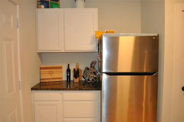 a white refrigerator freezer sitting inside of a kitchen