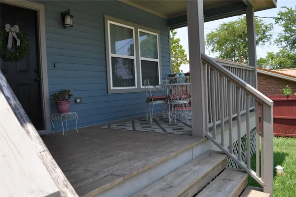 a view of deck with furniture and trees