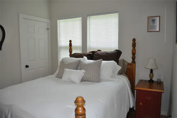 a bedroom with bed and window