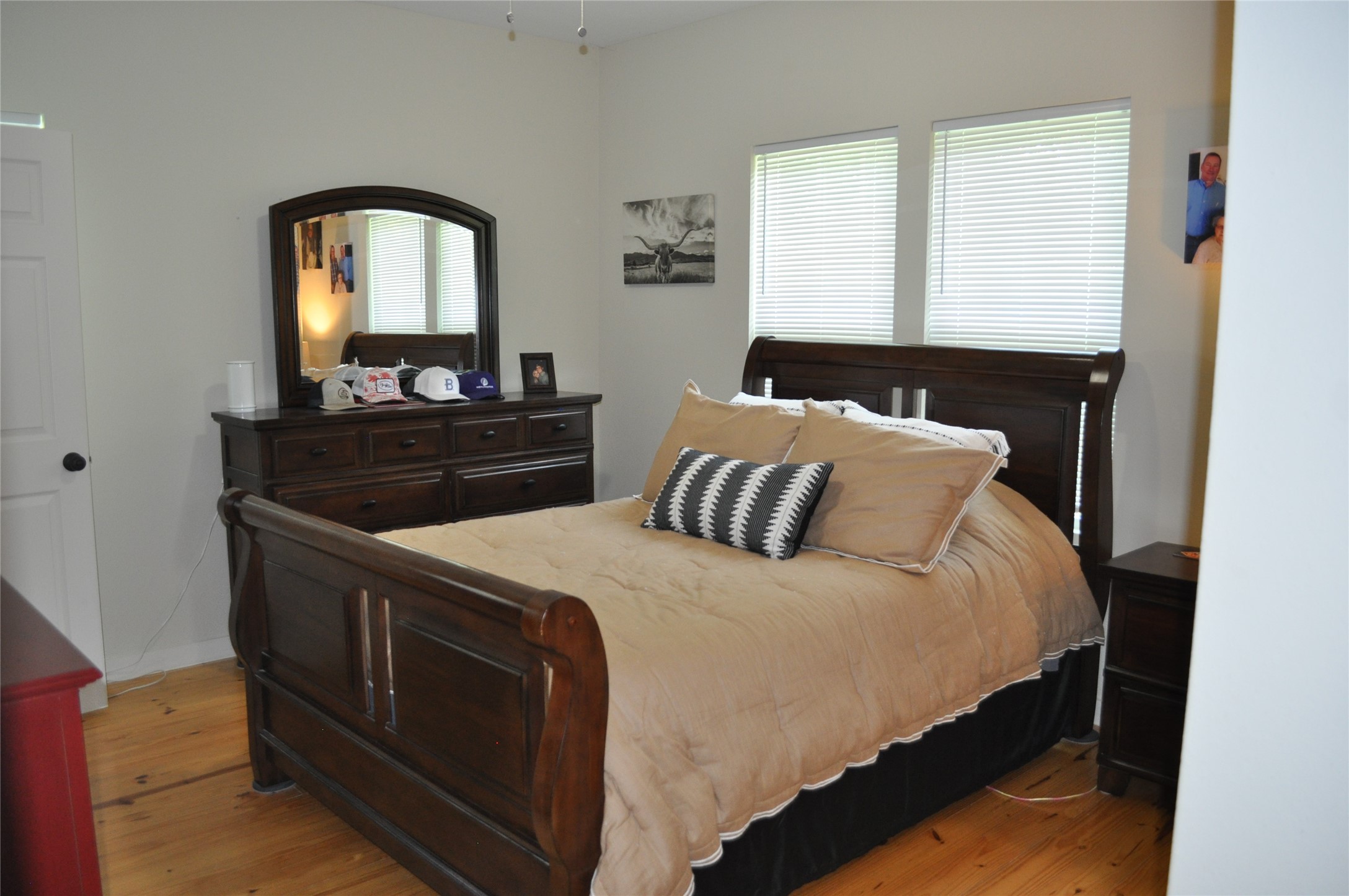 913 Independence Street Brenham, TX 77833 - Photo 22 of 24 a bedroom with a bed and a mirror on dresser