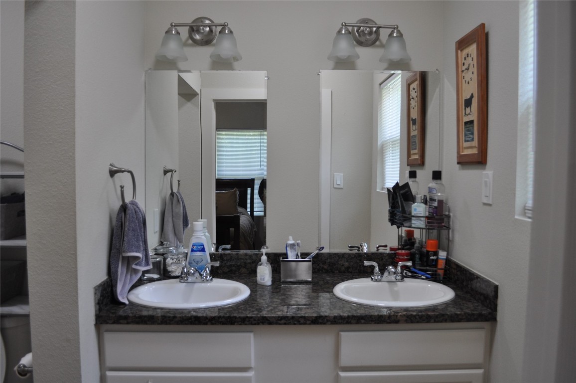 913 Independence Street Brenham, TX 77833 - Photo 23 of 24 a bathroom with double vanity sinks and a mirror