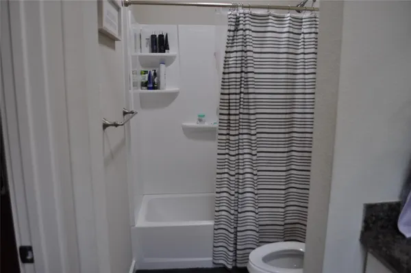 a bathroom with a shower and a toilet