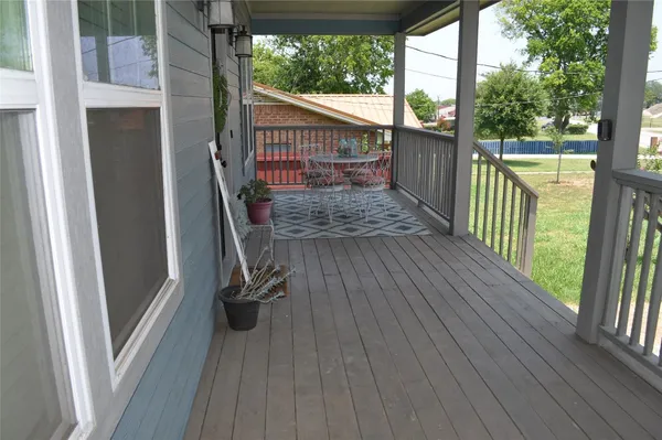 a view of a balcony with wooden floor