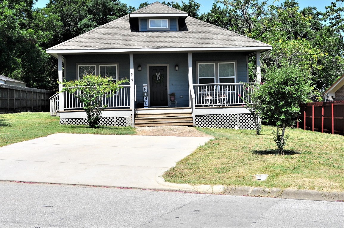 913 Independence Street Brenham, TX 77833 - Photo 7 of 24 a front view of a house with a garden