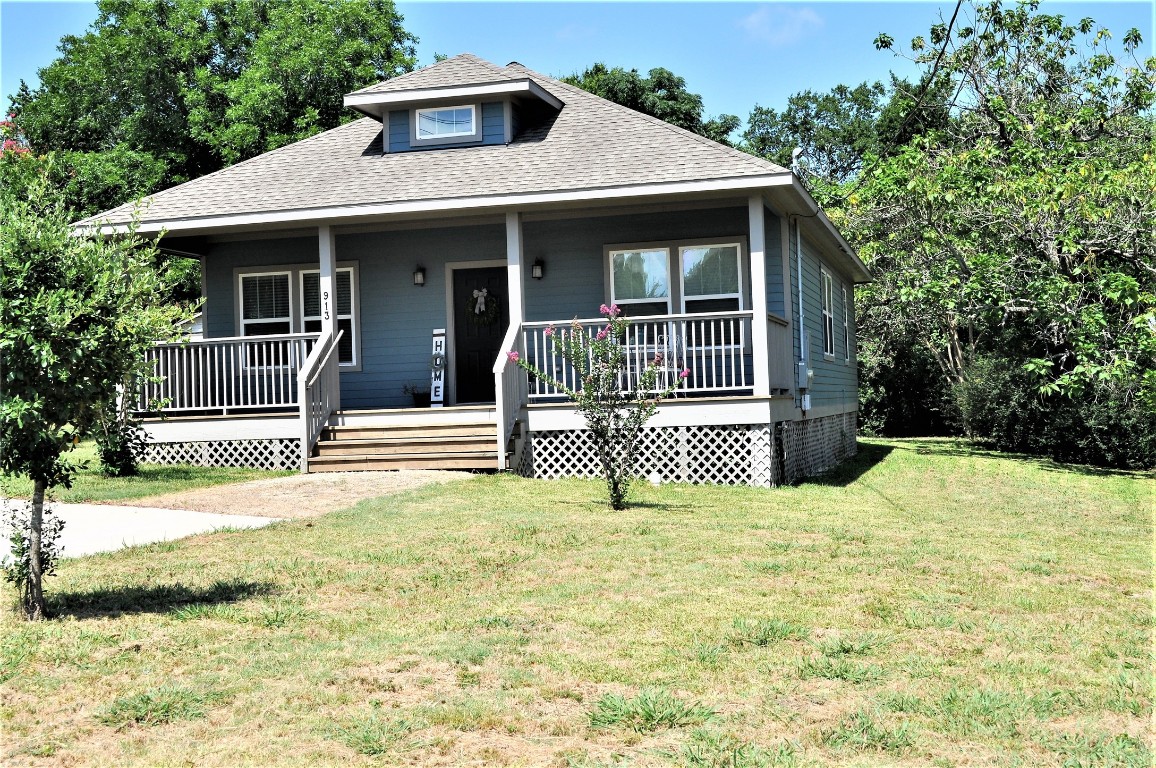 913 Independence Street Brenham, TX 77833 - Photo 8 of 24 a front view of a house with a yard