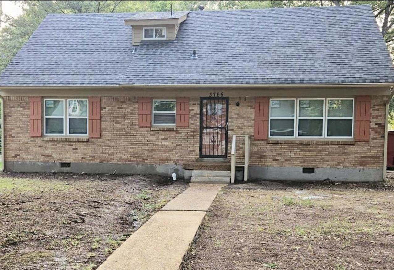 a view of a brick house with a large window