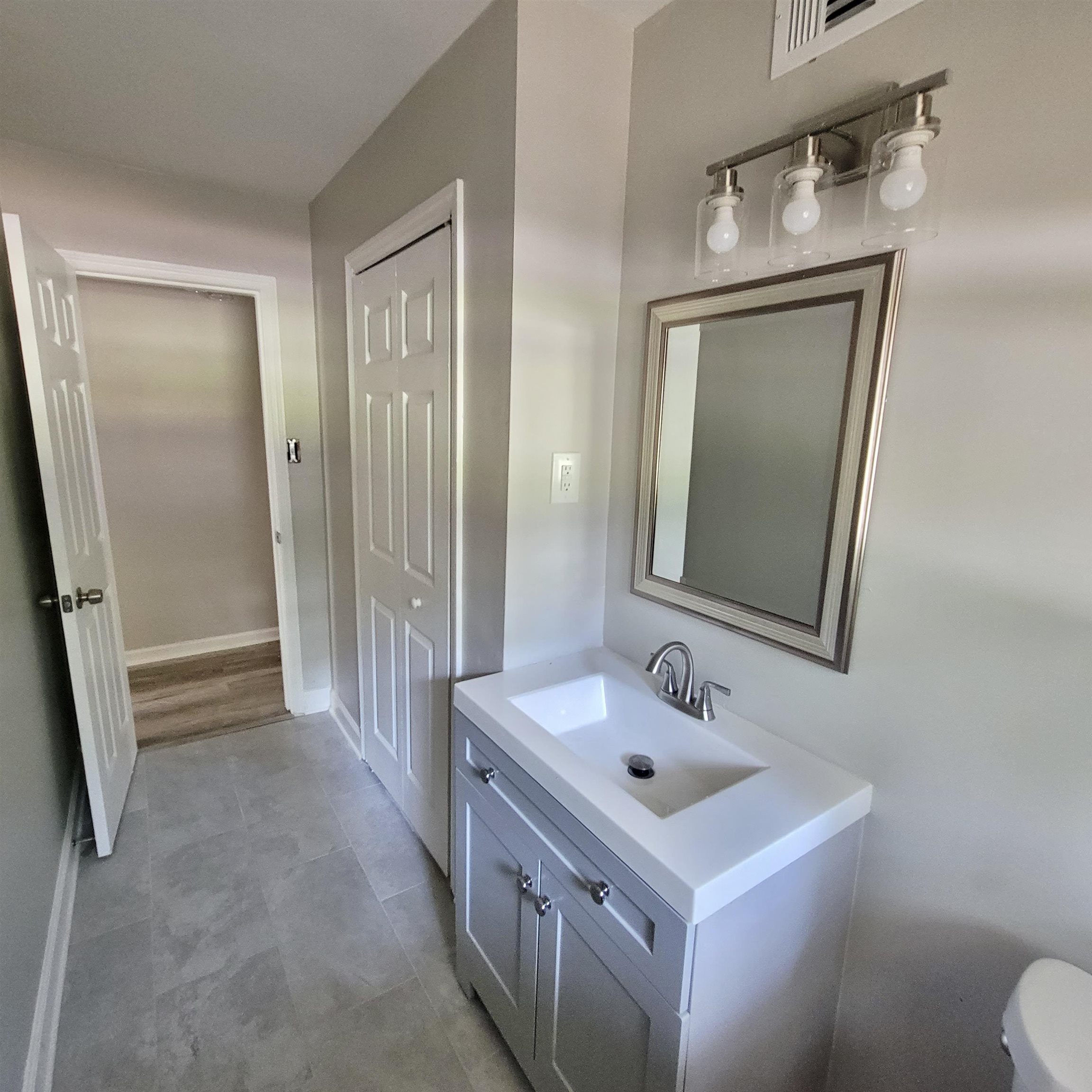 3765 Cazassa Road Memphis, TN 38116 - Photo 8 of 19 a bathroom with a sink a toilet a mirror and vanity