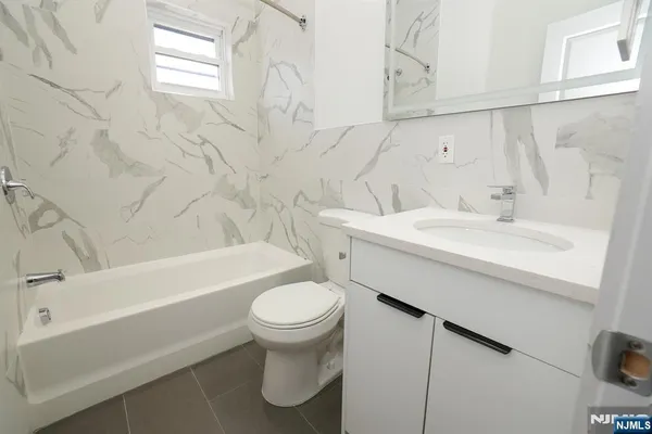 a bathroom with a sink a toilet and bathtub