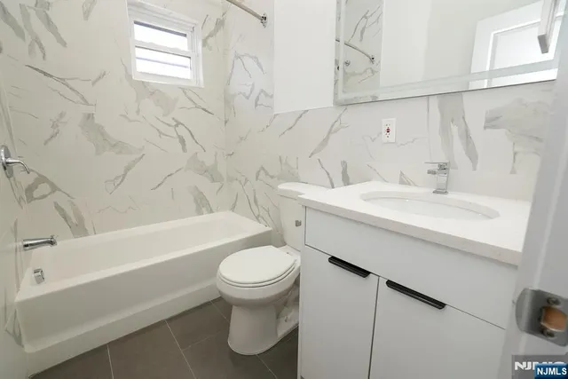 a bathroom with a sink a toilet and bathtub