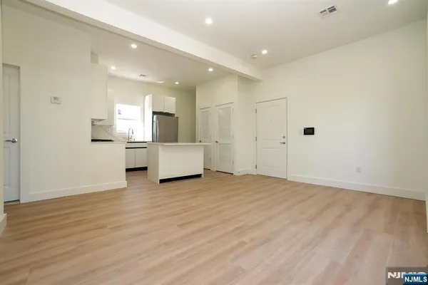 a view of a kitchen with a sink and a refrigerator