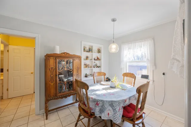 a view of a dining room with furniture and chandelier