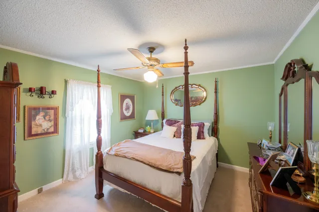 a bed room with a bed mirror and a window