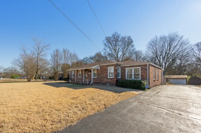 a view of a house with a yard covered in snow