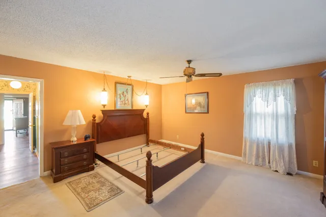 a living room with a furniture and large windows