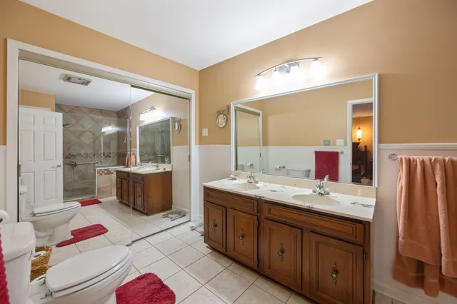 a bathroom with a tub sink shower and mirror