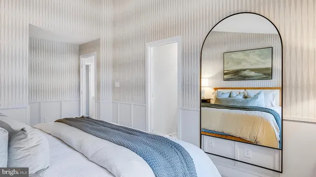 a bedroom with a bed and a painting on the wall