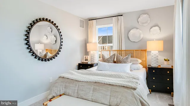 a bedroom with a bed and a mirror