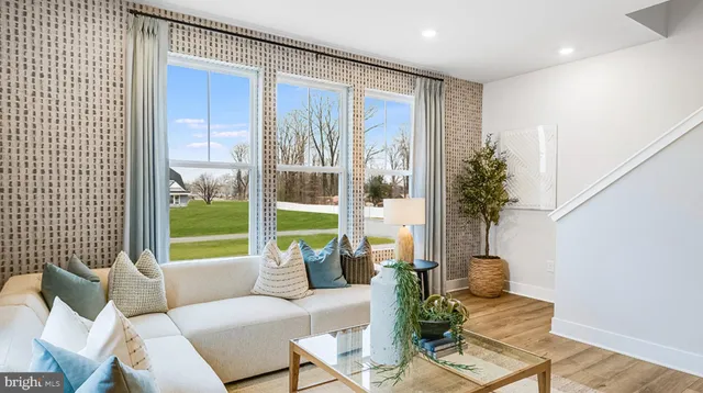 a living room with furniture and a floor to ceiling window