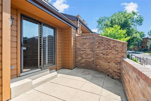 a view of a brick house with an outdoor space
