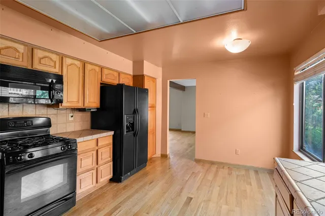 a kitchen with a stove a refrigerator and a cabinets