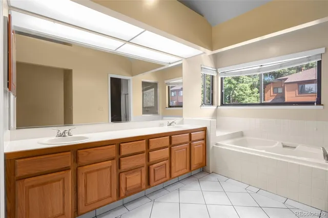 a white bath tub sitting in a bathroom next to a window