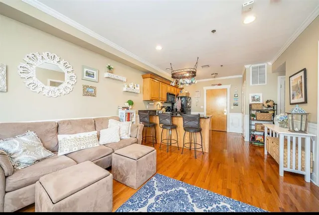 a living room with furniture a rug and a large window